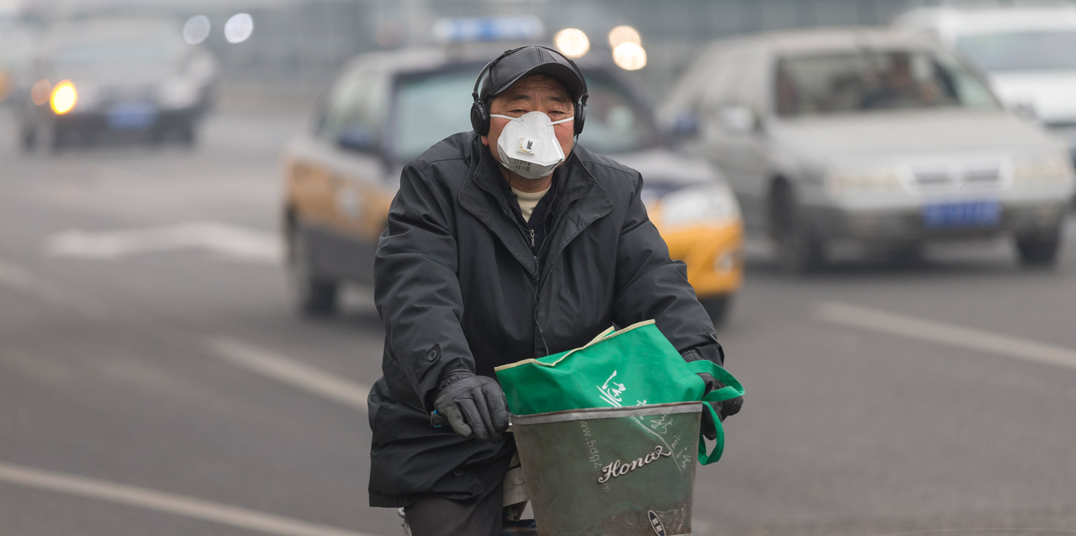 Man on bicycle with mask