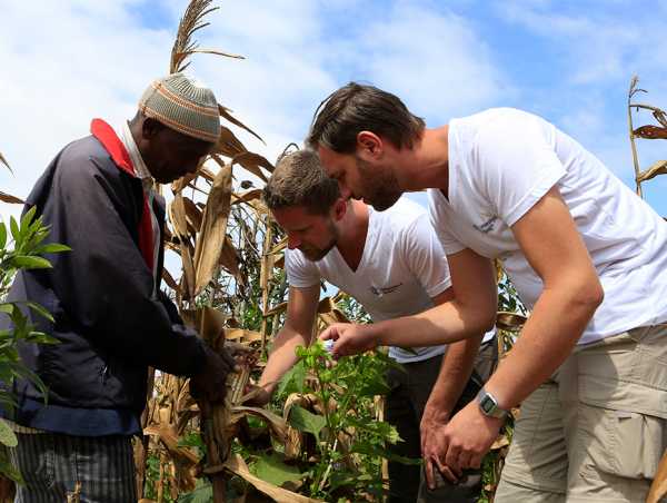 researchers talking to a farmer